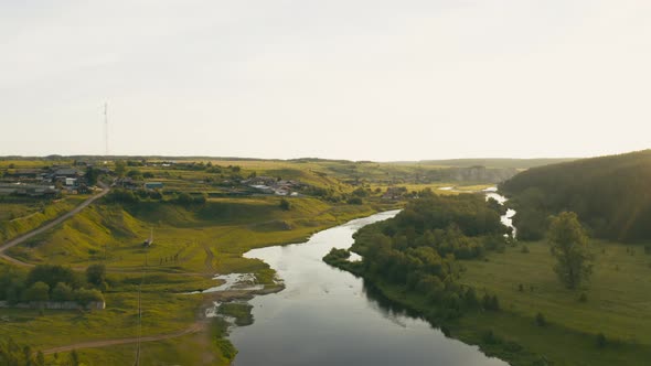 Aerial View of the River with Smooth Water and Forest on the Banks
