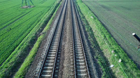 The railroad tracks seen from above, above the traction line.
