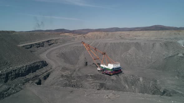 Aerial View to Career Walking Excavator Removes Waste Rock Digging Out Layer of Useful Material