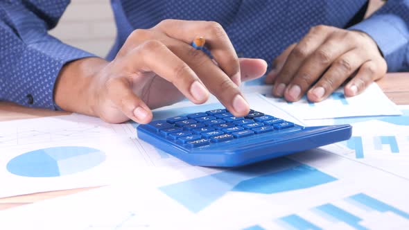 Close Up of Man Hand Using Calculator alt
