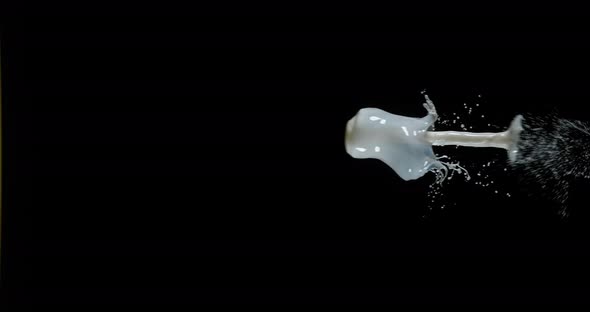 Milk Exploding and Splashing on Black Background, Slow Motion 4K alt