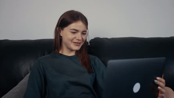 The Redhaired Happy Girl Calls Her Parents From Abroad Greets Them with a Wide Smile and Tells Them alt