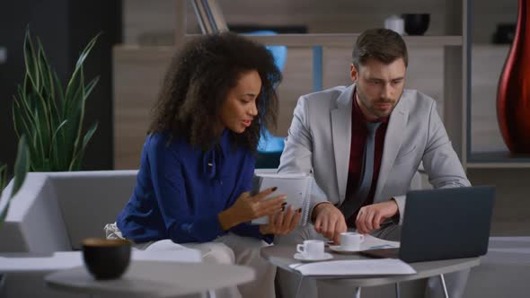Multiracial Coworkers Team Discuss Marketing Project Using Laptop in Cafe Office alt