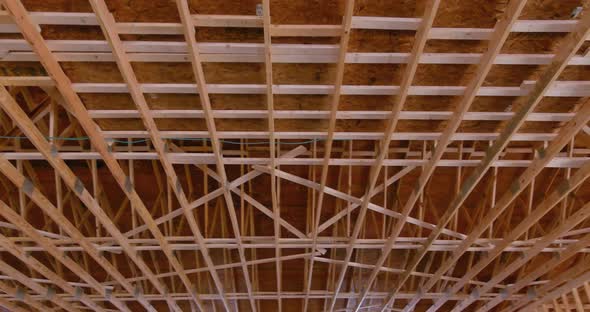 An Interior Viewed of Wooden Beams at Construction the Roof Truss System alt