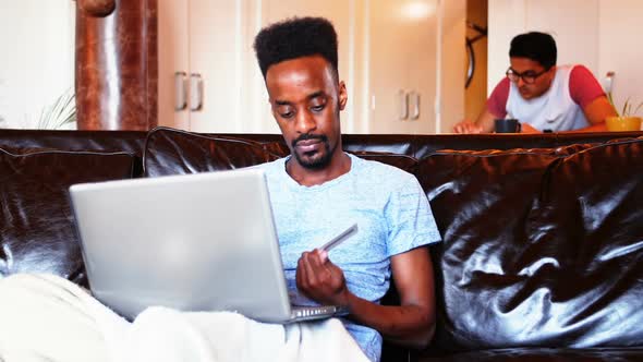 Man doing online shopping on laptop alt