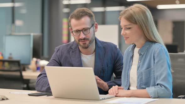 Middle Aged Businessman and Businesswoman Talking on Video Call on Laptop alt