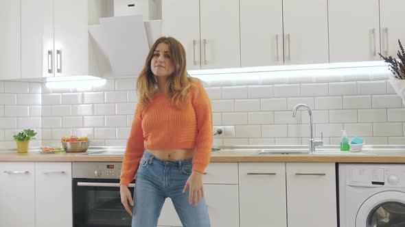 Young Happy Woman Dancing in Kitchen and Having Some Fun alt