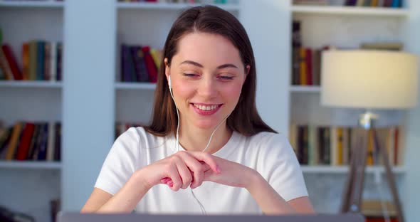 Happy Young Woman in Headset Conducting Online Lesson in Application Laptop