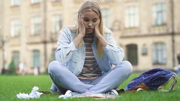 Student Woman Sitting on The Lawn and Working