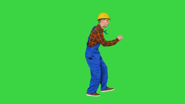 Dancing Young Engineer with Helmet After Work on a Green Screen, Chroma Key alt