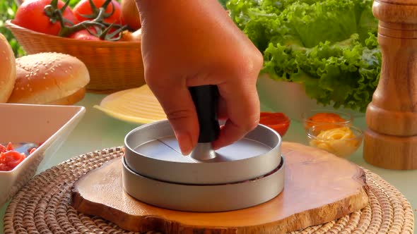 Closeup of the Hand Pressing Minced Meat Into a Form for Making a Meat Cutlet alt