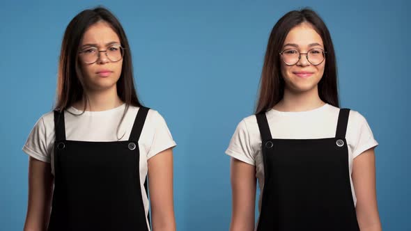Portrait of Young Asian Girl on Blue. Woman Depicts Emotion of Approving, Agreement and Rejection  alt