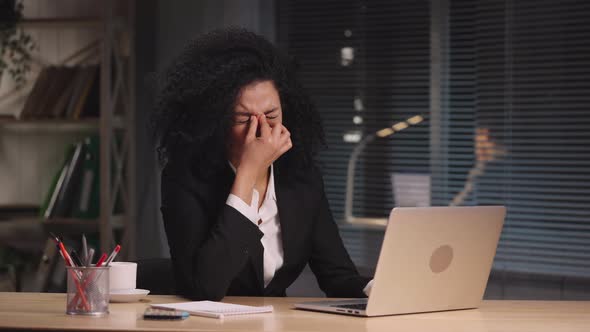 Portrait of Tired African American Woman Suffers From Overwork and Headache alt