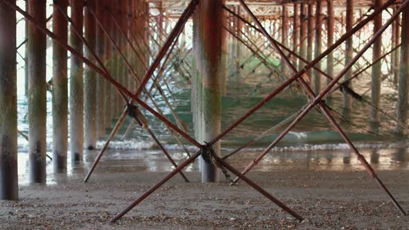 Man Walking Under Pier and Receives a Phone Call From A Good Friend alt