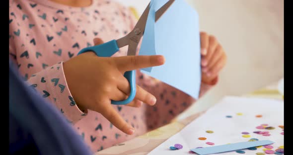 Toddler cutting with scissors and doing crafts