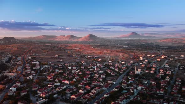Aerial Drone Footage of Cappadocia Town and Mountains on the Background alt