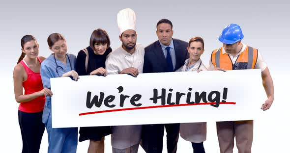 Various professional holding placard of were hiring text alt