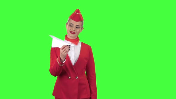 Girl Is Launching a Paper Airplane. Green Screen alt