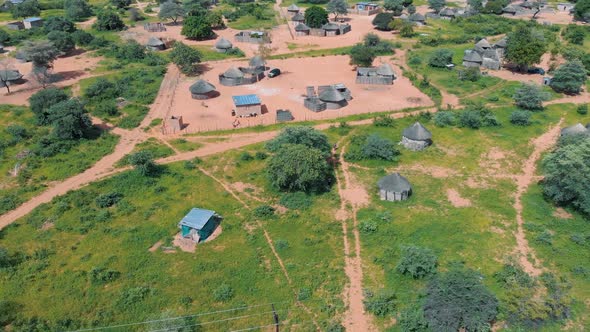 Aerial view footage of small village with huts in Africa