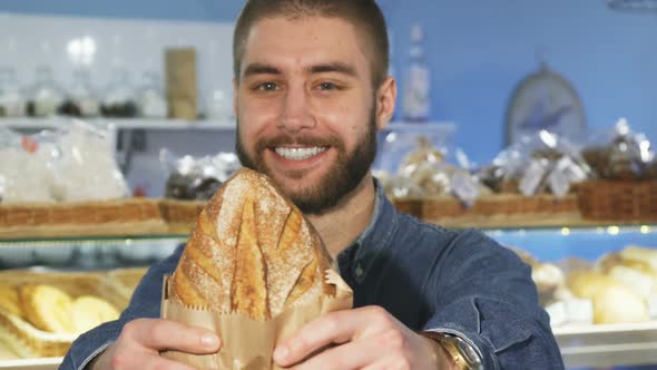 Happy Handsome Bearded Man Posing with Freshly Baked Bread