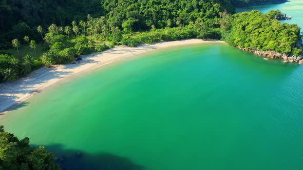 An aerial view of the unique turquoise waters and beautiful mountain coast alt
