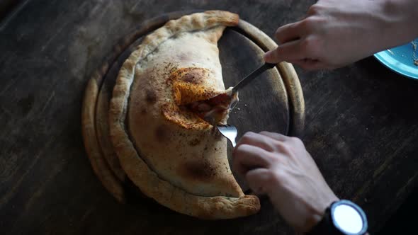 Pizza puff calzone with hand and knife cutting video 4k