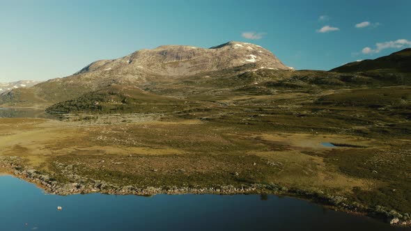 Summer Blue Sky And Mountain Reflections On Calm Lake In Hemsedal, Norway - Wide Shot (Pull-Back) alt