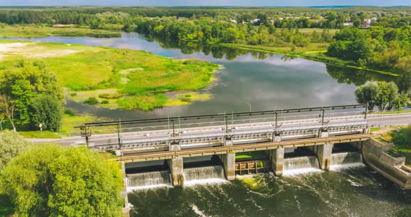 Hyperlapse From a Drone Overlooking a Bridge with a Dam alt
