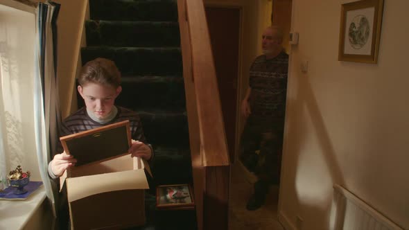 Boy showing old picture frame alt