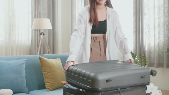 Asian Woman Preparing For Travel Adventure, Packing Clothes Into Suitcase, Getting Ready For Trip alt