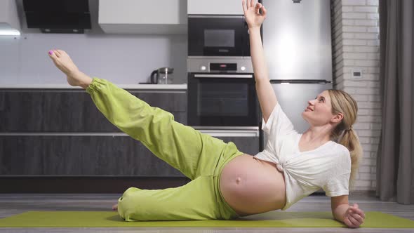 A Woman Waiting for a Baby Trains Stretches Her Muscles Does Fitness for Pregnant Women Sports Yoga