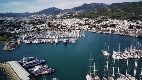 Amazing panoramic view from drone of full of yachts Bodrum harbour and ancient Kalesi castle.