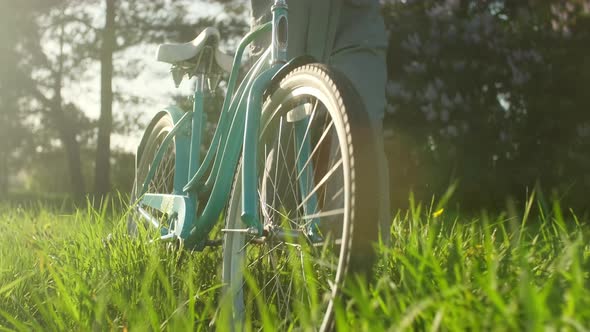Close Up Cyclist Woman Walk With Bicycle On Countryside Road At Summer Time alt