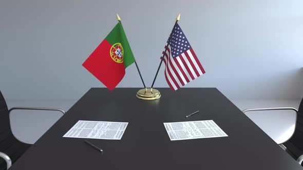 Flags of Portugal and the United States of America on the Table alt