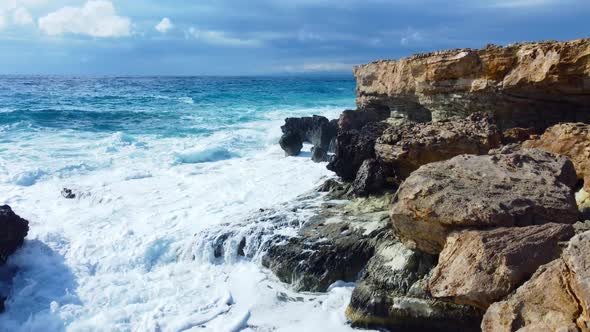 Aerial View of Waves Break on Rocks in a Blue Ocean Sea Waves on Beautiful Beach Bird's Eye View of alt