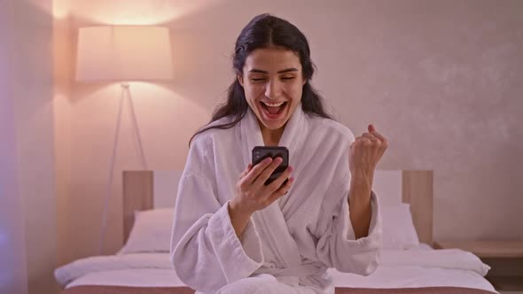 Portrait of Happy Business Woman Enjoy Success on Mobile Phone at Home Office