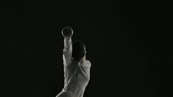 Fencer Woman Training Fencing Exercise in Studio Indoors. The Female Athlete Is Practicing an Attack alt