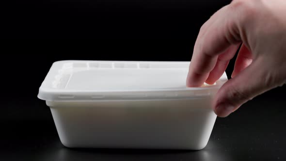 Caucasian Hand Opening Rectangular Styrofoam Container with Hot Cooked Instant Noodles