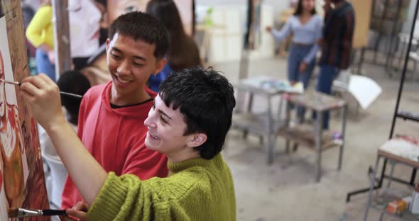 Young multiracial students doing canvas painting inside artistic classroom at college university alt