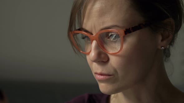 Close Up Portrait of Beautiful Serious Woman in Glasses Reflecting Computer Screen