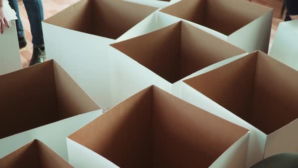 Women Manually Make Cardboard Boxes