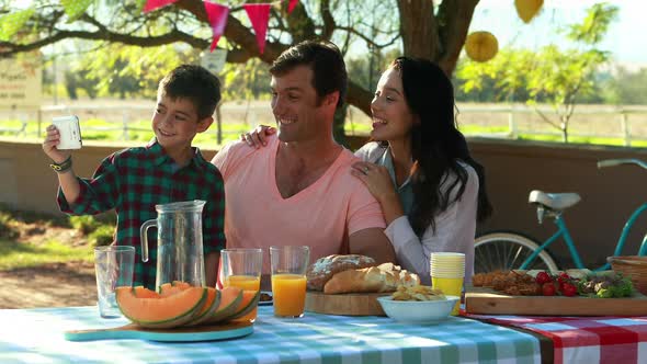 Happy family taking selfie in park 4k alt