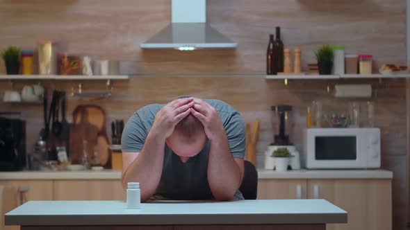 Husband with Headache Taking Pills alt