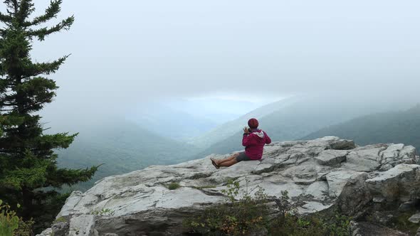 A woman sits at the Rohrbaugh Cliffs in the Dolly Sods Wilderness, part of the Monongahela National alt