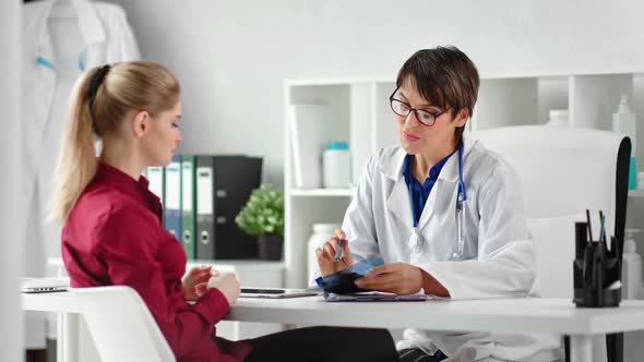 Professional Female Medic Consultation Young Woman Looking at Xray Image Surrounded By Hospital alt