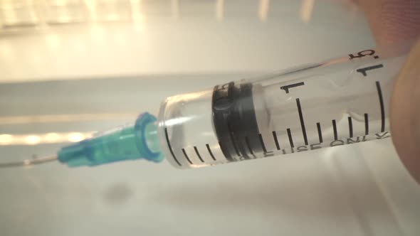 Doctor's Hand Holds a Syringe and a Vaccine Bottle at the Hospital. Health and Medical Concepts alt