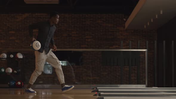 One Black AfricanAmerican Man Throws a Bowling Ball and Knocks Out a Clash Dancing Jumping and alt
