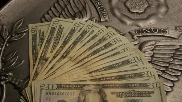 Rotating footage shot of American paper currency on an American eagle shield background - MONEY 0401 alt