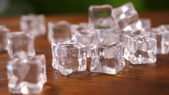 Ice Cubes on Brown Wooden Background