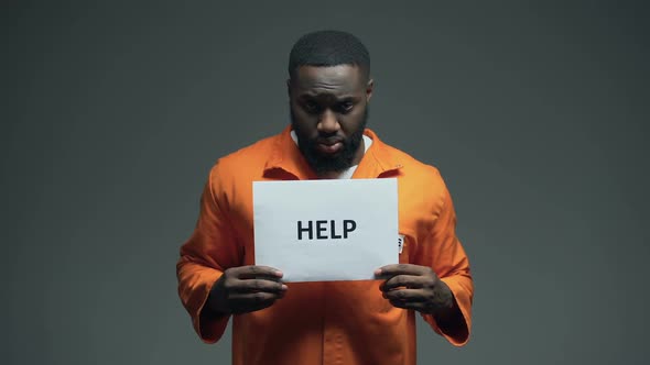 African-American Male Prisoner Holding Help Sign, Asking for Justice, Abuse alt